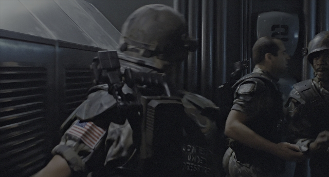 Wide shot frame from Aliens — standing, room, dialogue