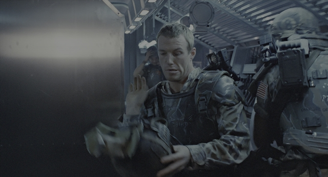 Wide shot frame from Aliens — standing, room, uniform