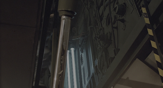 Wide shot frame from Aliens — pipe, window, running