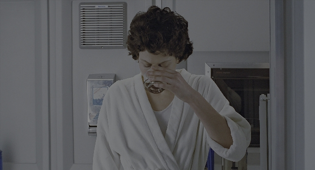 Wide shot frame from Aliens — standing, kitchen, hand