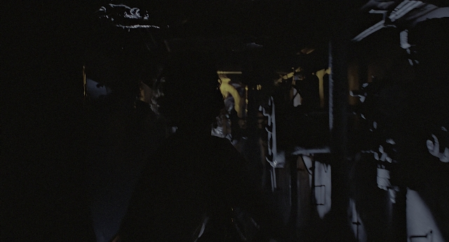 Wide shot frame from Aliens — standing, room, face