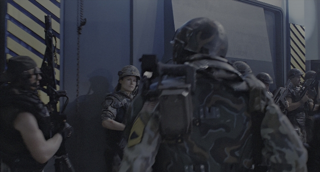 Wide shot frame from Aliens — standing, room, person