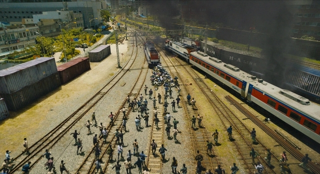 Wide shot frame from Busanhaeng — walking, train, smoke