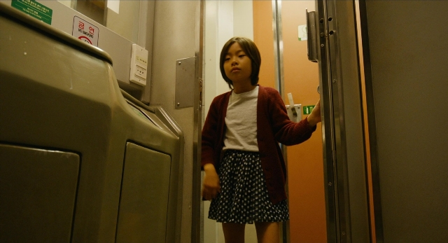 Wide shot frame from Busanhaeng — standing, door, shirt