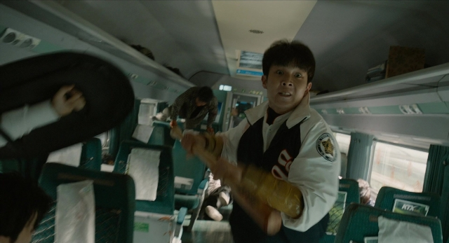 Wide shot frame from Busanhaeng — standing, car, shirt