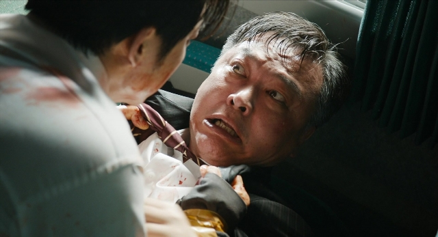 Wide shot frame from Busanhaeng — standing, car, suit