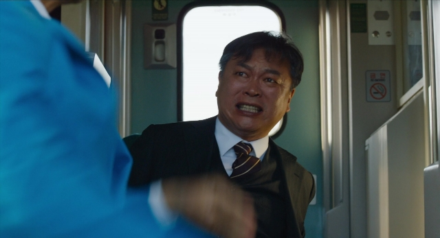 Wide shot frame from Busanhaeng — standing, door, hand