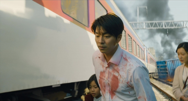 Wide shot frame from Busanhaeng — standing, shirt, train