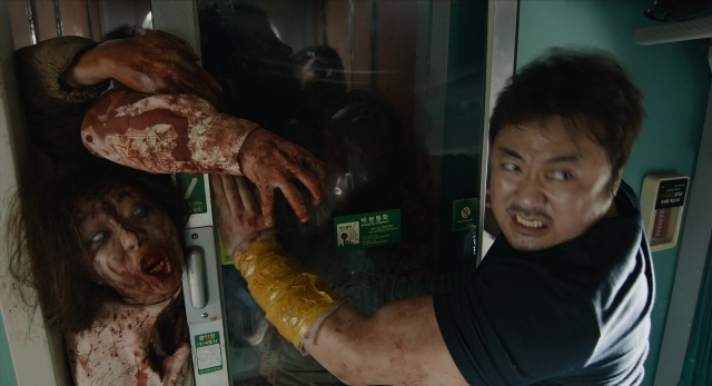 Wide shot frame from Busanhaeng — room, door, hand