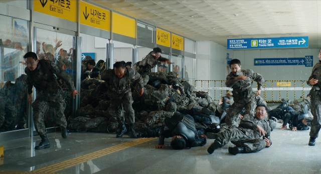 Wide shot frame from Busanhaeng — standing, person, human face