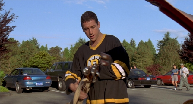 Wide shot frame from Happy Gilmore — standing, car, hand