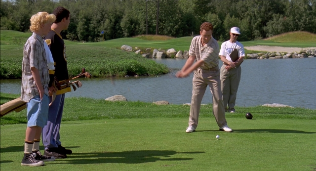 Wide shot frame from Happy Gilmore — standing, hat, shirt