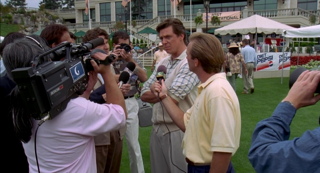 Wide shot frame from Happy Gilmore — standing, dialogue, shirt