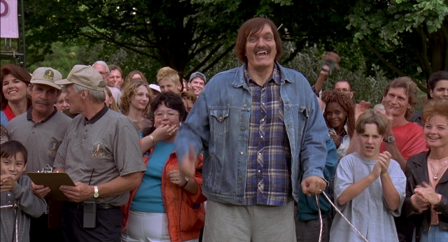 Wide shot frame from Happy Gilmore — standing, hat, shirt