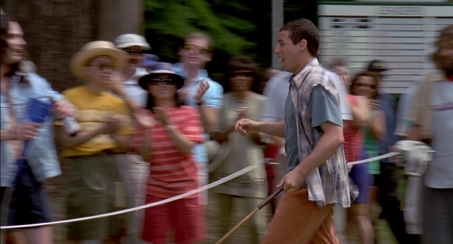 Wide shot frame from Happy Gilmore — walking, street, hand
