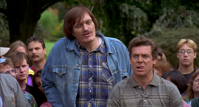 Wide shot frame from Happy Gilmore — standing, dialogue, shirt