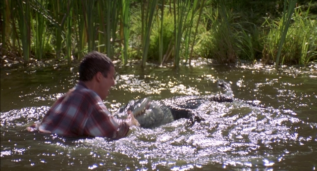 Wide shot frame from Happy Gilmore — shirt, water, face
