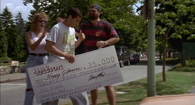 Wide shot frame from Happy Gilmore — standing, street, hat