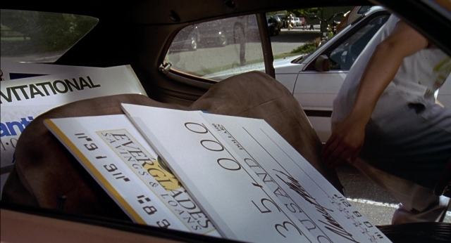 Frame from Happy Gilmore — door, street, car