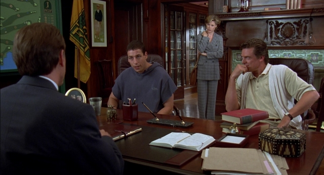 Medium shot frame from Happy Gilmore — sitting, book, standing