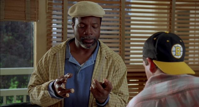 Wide shot frame from Happy Gilmore — sitting, plate, room
