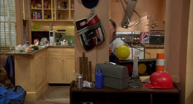 Frame from Happy Gilmore — table, hat, kitchen