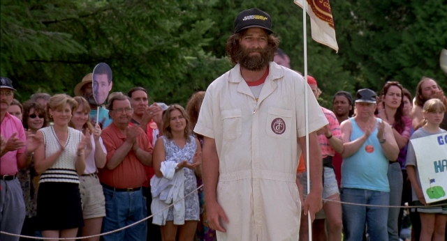 Wide shot frame from Happy Gilmore — standing, hat, shirt