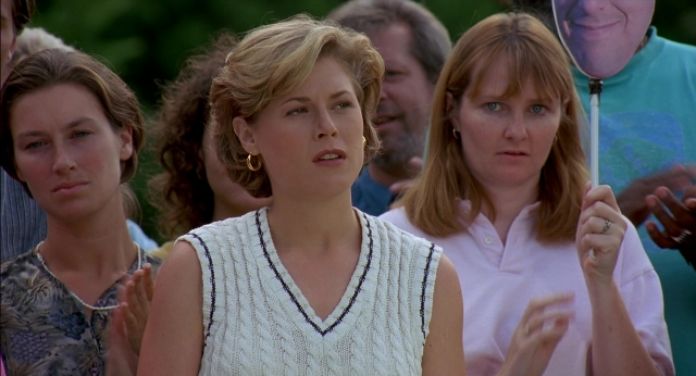Wide shot frame from Happy Gilmore — standing, mirror, face