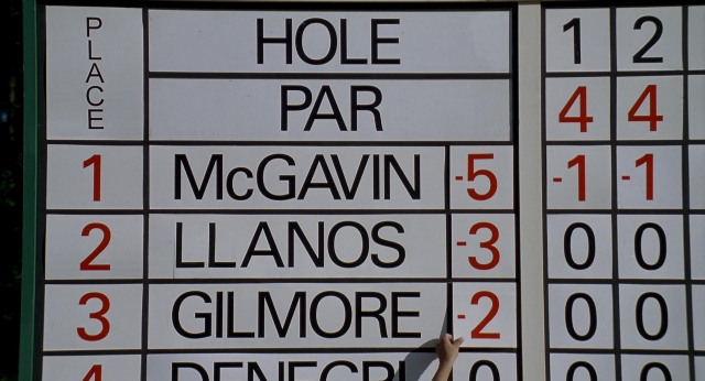 Wide shot frame from Happy Gilmore — hand, scoreboard, person