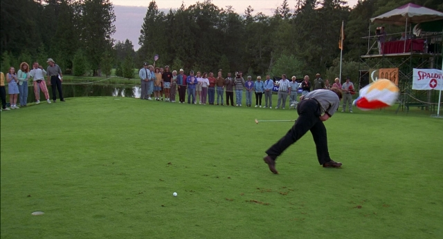 Wide shot frame from Happy Gilmore — hand, shirt, person