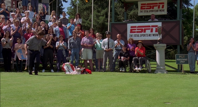 Wide shot frame from Happy Gilmore — standing, person, human face