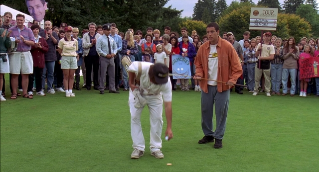 Wide shot frame from Happy Gilmore — standing, hat, shirt