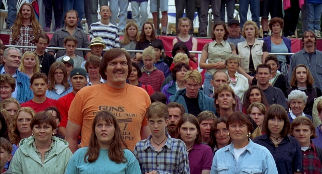 Wide shot frame from Happy Gilmore — standing, dialogue, shirt