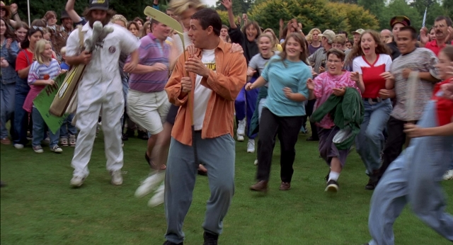 Wide shot frame from Happy Gilmore — suit, person, footwear