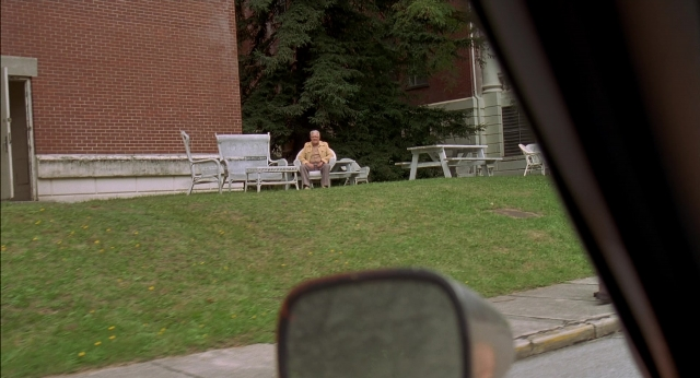 Wide shot frame from Happy Gilmore — sitting, table, mirror