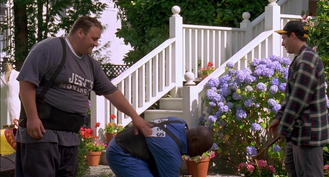 Wide shot frame from Happy Gilmore — standing, shirt, flower