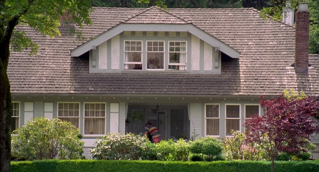 Wide shot frame from Happy Gilmore — standing, door, house