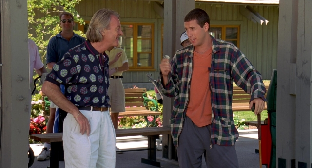 Wide shot frame from Happy Gilmore — standing, dialogue, hand