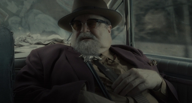Frame from Inside Llewyn Davis — sitting, hat, car