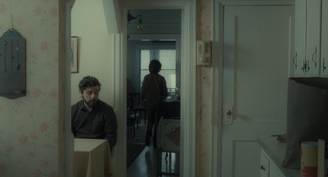 Wide shot frame from Inside Llewyn Davis — standing, walking, door