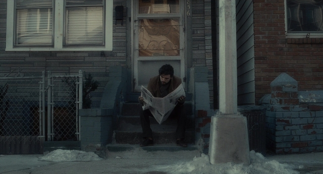Wide shot frame from Inside Llewyn Davis — sitting, door, house