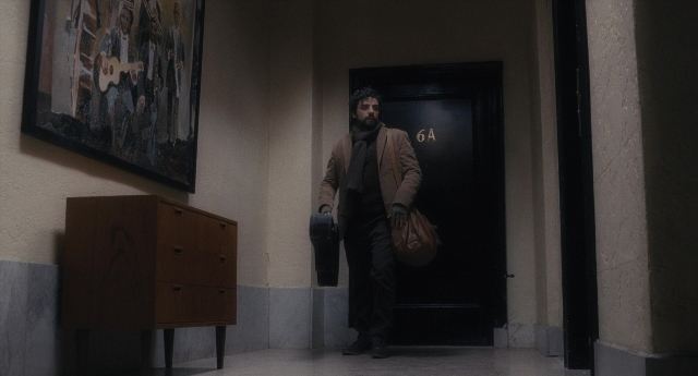 Wide shot frame from Inside Llewyn Davis — standing, door, coat
