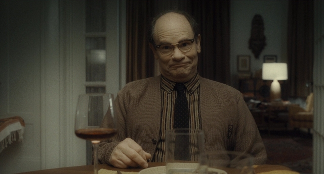 Medium shot frame from Inside Llewyn Davis — sitting, room, table