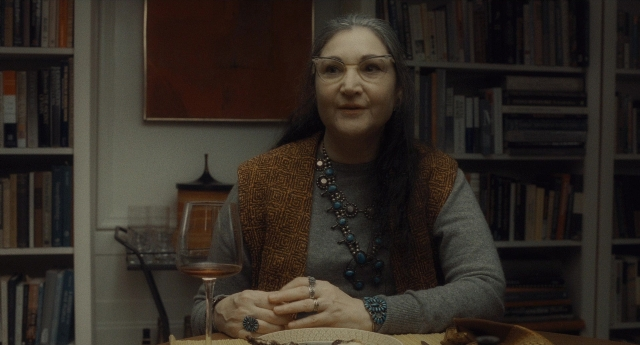 Wide shot frame from Inside Llewyn Davis — sitting, book, plate
