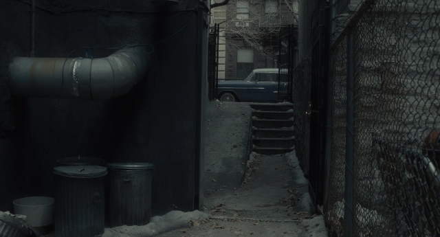 Wide shot frame from Inside Llewyn Davis — street, car, water