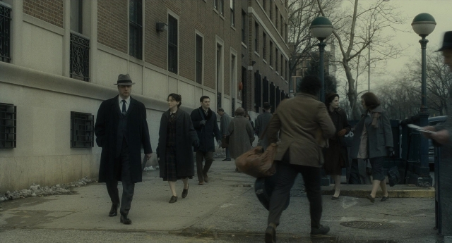 Wide shot frame from Inside Llewyn Davis — walking, street, hat