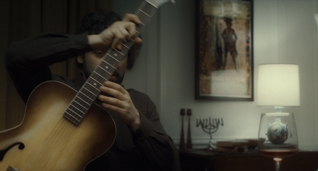 Wide shot frame from Inside Llewyn Davis — sitting, room, shirt