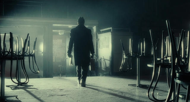 Medium shot frame from Inside Llewyn Davis — walking, room, hat