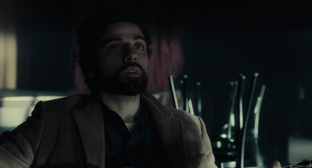 Medium shot frame from Inside Llewyn Davis — sitting, room, beard