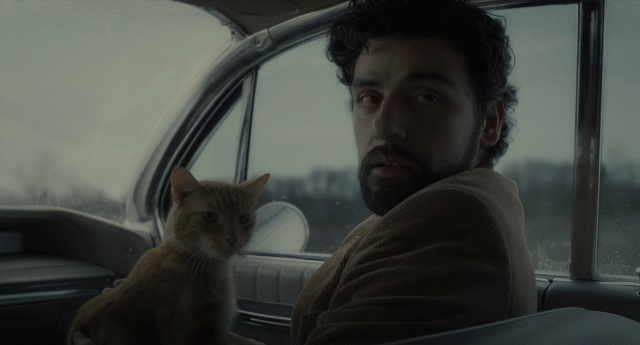 Medium shot frame from Inside Llewyn Davis — sitting, car, beard